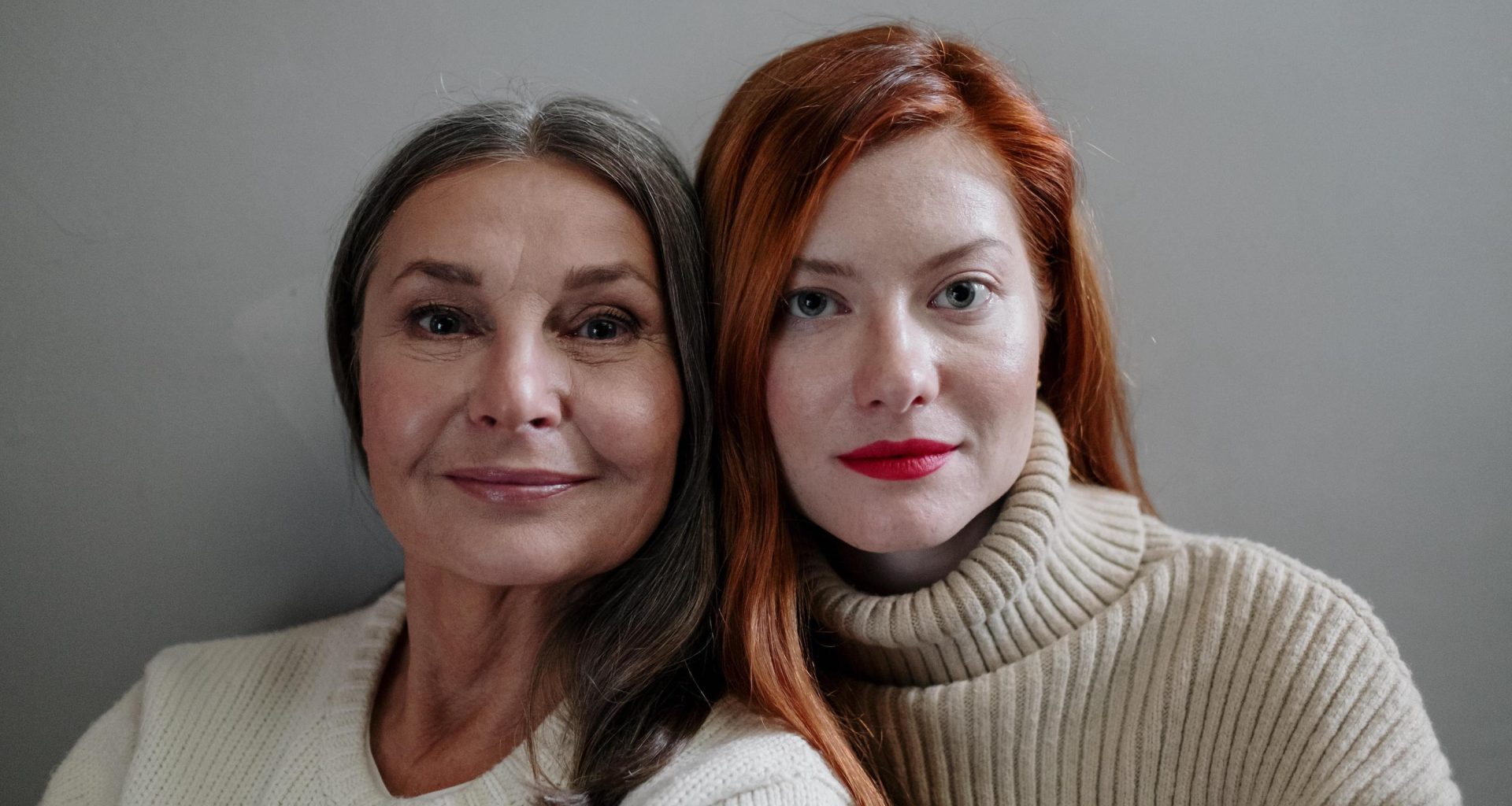 Two women stare into camera