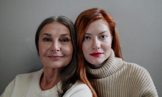 Two women stare into camera